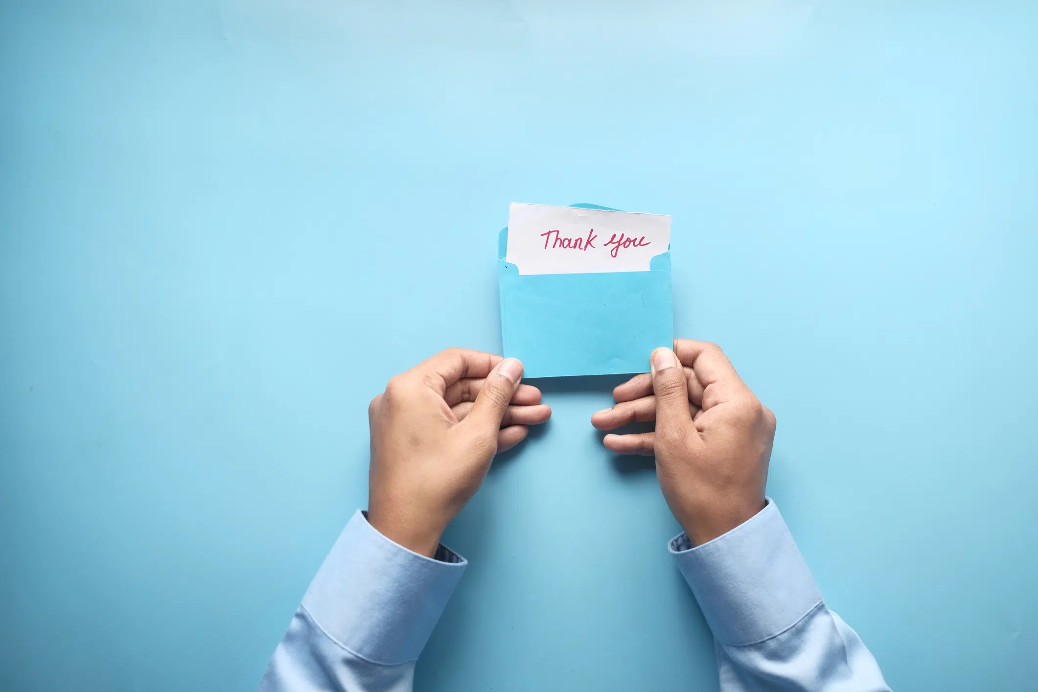 donation-thank-you-letter close up of man hand holding a thank you letter