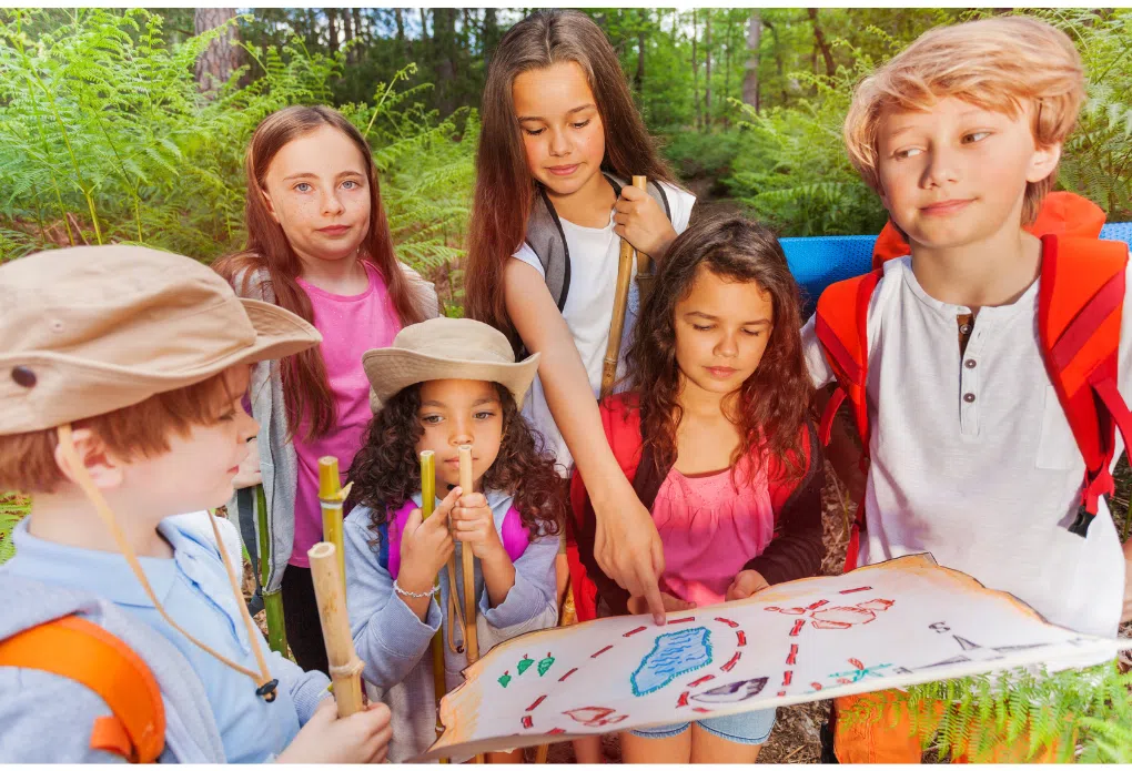 campers viewing a treasure hunt map