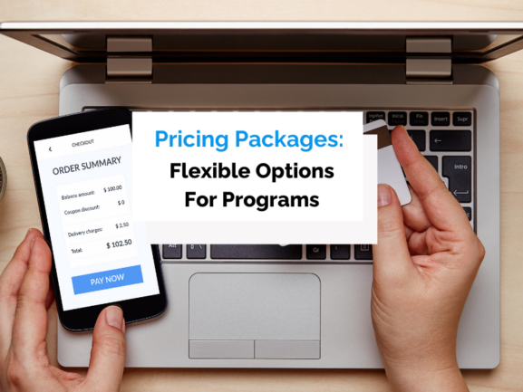 Man holding credit card over laptop with a phone in the other hand buying online