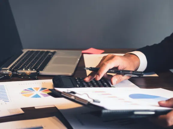 invoicing system on paper business man using calculator by laptop