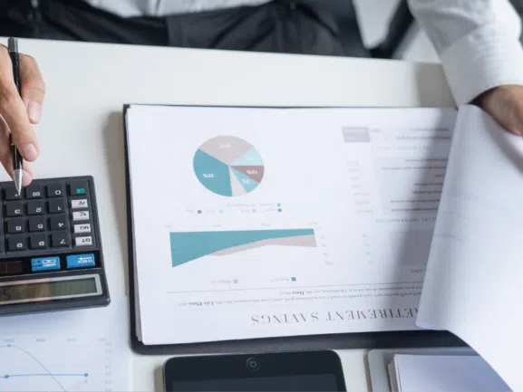 clipboard on a table with a pie chart and graph